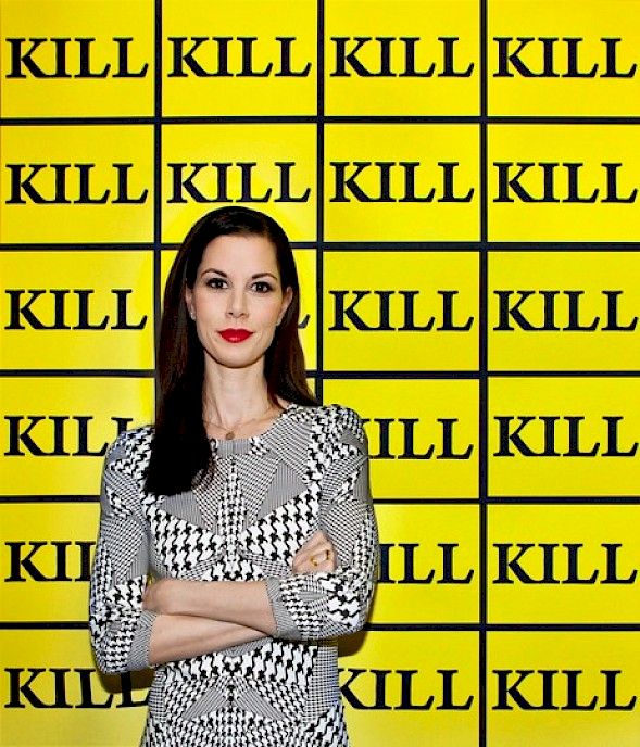 Julia Stoschek in front of the ’Kill-Wallpaper’ by Sturtevant (2003) in the exhibition ’Number Eight’ (2014), Photo: Şirin Şimşek