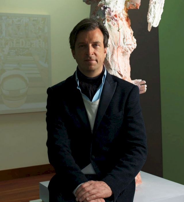 Portrait of Alain Servais. On wall: Matthew Day Jackson, ’Cult of Death #8’, 2009