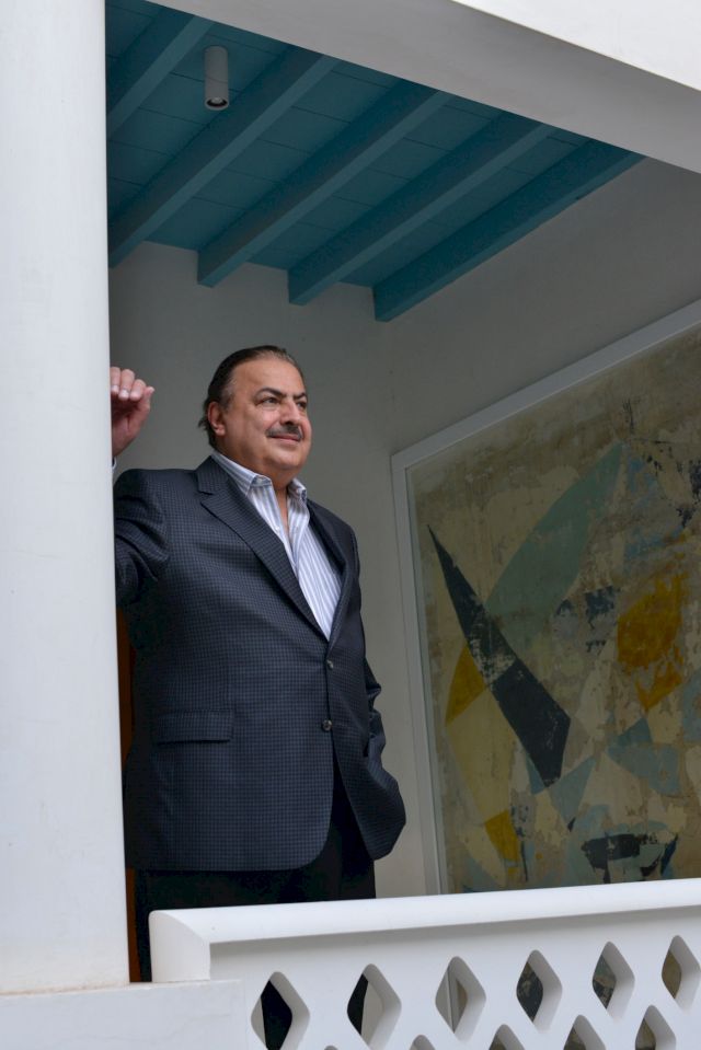 Rashid Al Khalifa in front of his painting from 1966, that he painted directly onto the wall, adjacent to his childhood bedroom, in his family home, now the RAK Art Foundation, Riffa, Bahrain